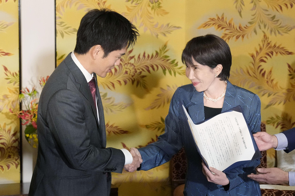 Japan’s Liberal Democratic Party President Sanae Takaichi, right, and leader of Japan Innovation Party, or Ishin no Kai, Hirofumi Yoshimura shake hands after signing an agreement to form a coalition government in Tokyo, Monday, Oct. 20, 2025. (Kyodo News via AP)