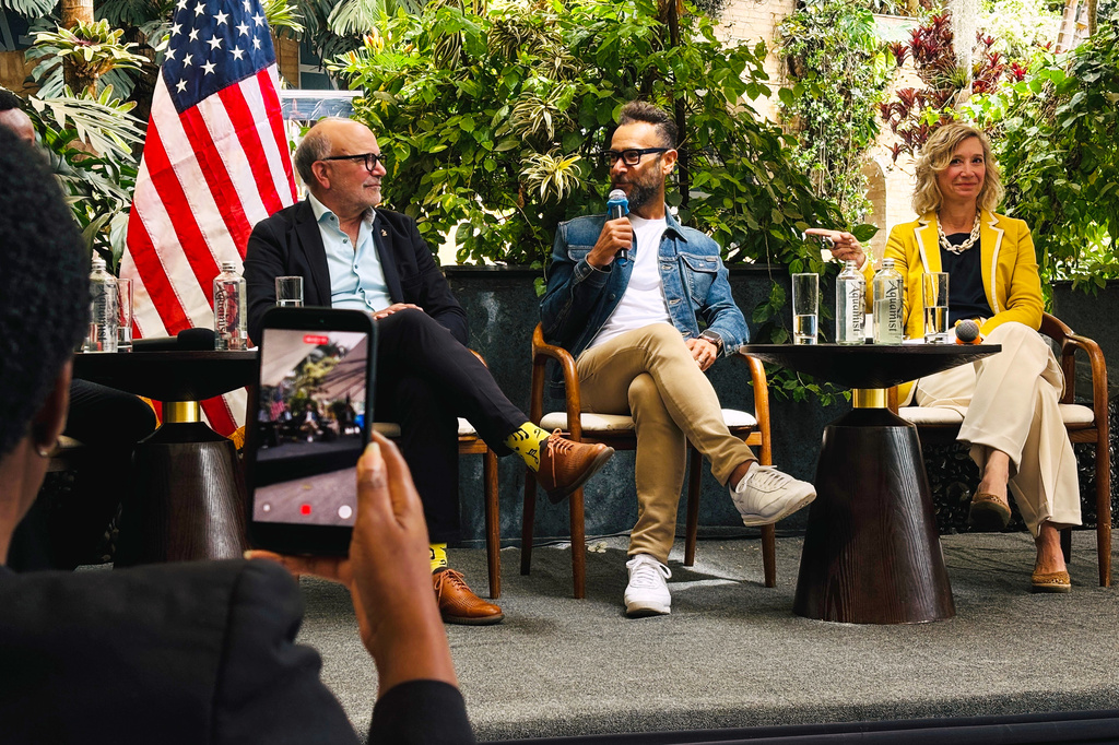 In this photo taken with a smartphone, The Latin America Recording Academy CEO Manuel Abud, The Recording Academy President Panos A. Panay, and Carla Benini, the acting deputy chief of mission for the U.S. Embassy, participate in a panel on Kenya's creative economy Friday, Sept. 11, 2026, in Nairobi, Kenya. (AP Photo/Jackson Njehia)