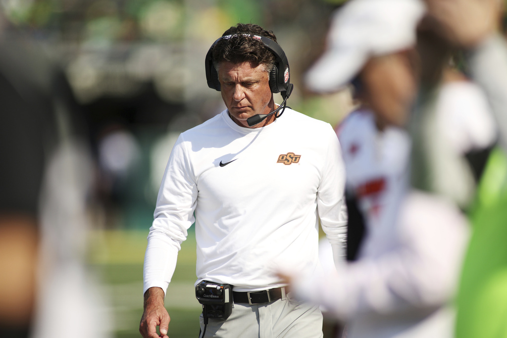Oklahoma State head coach Mike Gundy walks along the sideline during the second half of an NCAA college football game against Oregon, Saturday, Sept. 6, 2025, in Eugene, Ore. (AP Photo/Lydia Ely)