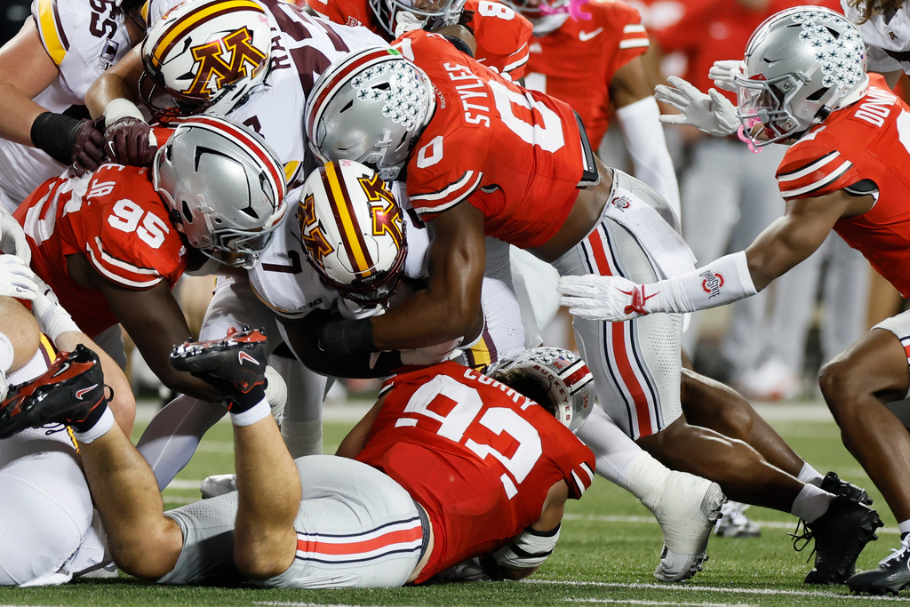 Ohio State defense swarms Minnesota running back Fame Ijeboi during the first half of an NCAA college football game, Saturday, Oct. 4, 2025, in Columbus, Ohio. (AP Photo/Jay LaPrete)