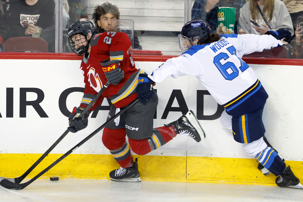 Toronto Sceptres' Renata Fast, right, is knocked down by Ottawa Charge's Fanuza Kadirova during first period PWHL Takeover Tour hockey game in Calgary, on Wednesday, April 1, 2026. (Larry MacDougal/The Canadian Press via AP)