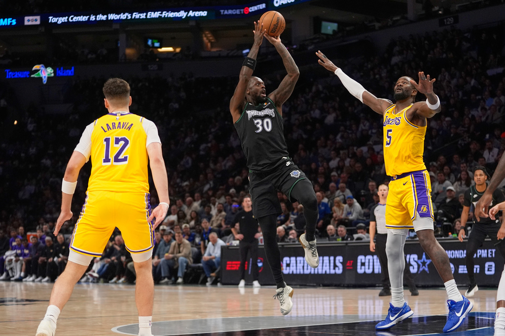Minnesota Timberwolves forward Julius Randle (30) shoots over Los Angeles Lakers center Deandre Ayton (5) during the first half of an NBA basketball game, Wednesday, Oct. 29, 2025, in Minneapolis. (AP Photo/Abbie Parr)