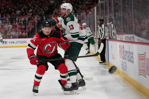 New Jersey Devils' Dawson Mercer, left, and Minnesota Wild's Yakov Trenin (13) look after the puck during the first period of an NHL hockey game Wednesday, Oct. 22, 2025, in Newark, N.J. (AP Photo/Seth Wenig) New Jersey Devils' Dawson Mercer, left, and Minnesota Wild's Yakov Trenin (13) look after the puck during the first period of an NHL hockey game Wednesday, Oct. 22, 2025, in Newark, N.J. (AP Photo/Seth Wenig)