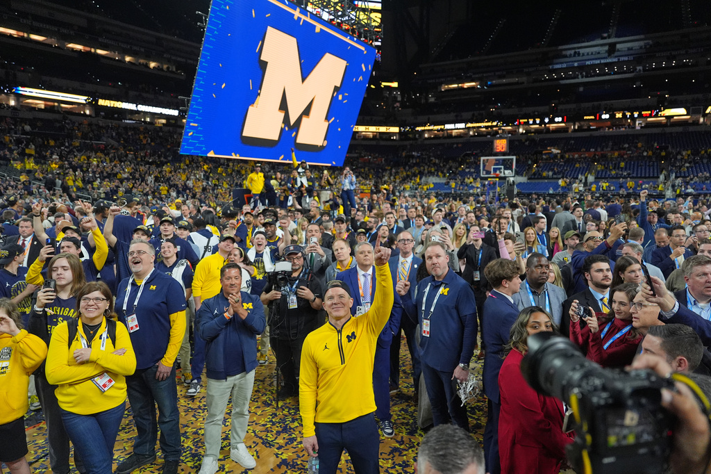 FILE - Michigan head coach Dusty May celebrates after defeating UConn in the NCAA college basketball tournament national championship game at the Final Four, April 7, 2026, in Indianapolis. (AP Photo/Michael Conroy, File)