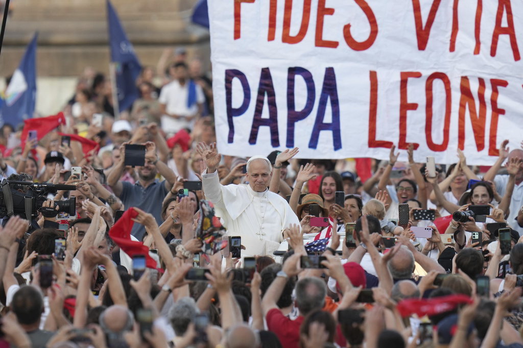 FILE - Pope Leo XIV waves as he arrives to hold a Pentecost vigil in St. Peter's Square at The Vatican, Saturday, June 8, 2025. (AP Photo/Alessandra Tarantino, File)