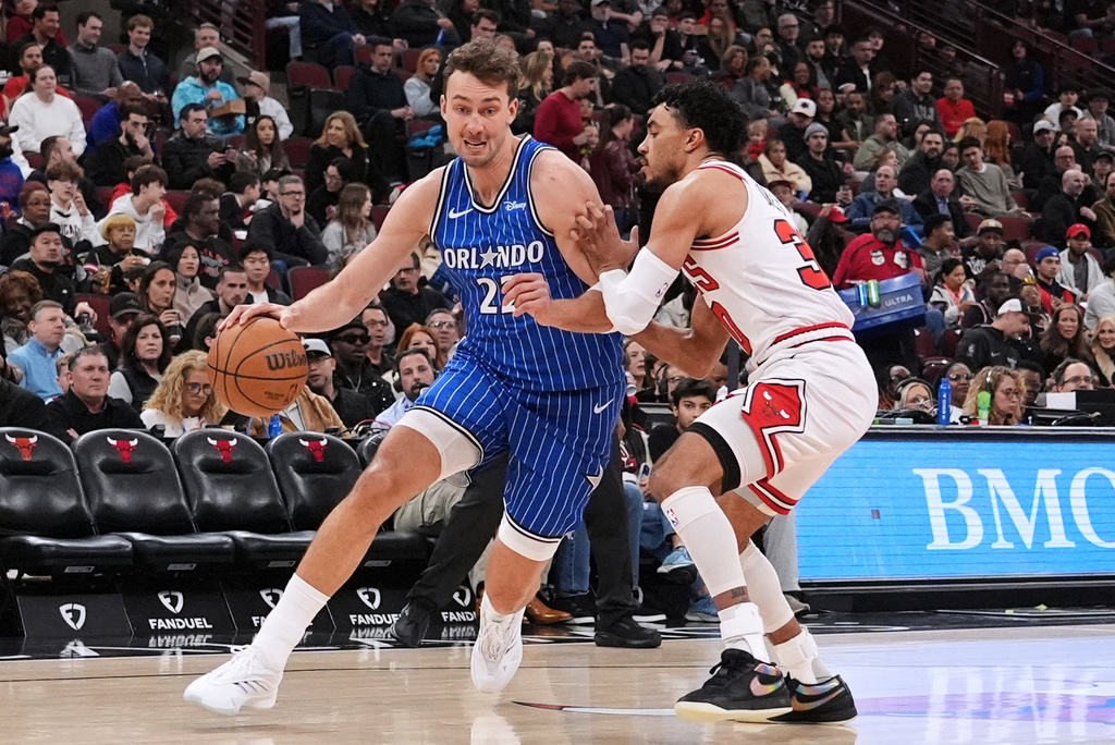 Orlando Magic forward Franz Wagner, left, drives as Chicago Bulls guard Tre Jones, right, defends during the first half of an NBA basketball game in Chicago, Friday, April 10, 2026. (AP Photo/Nam Y. Huh)