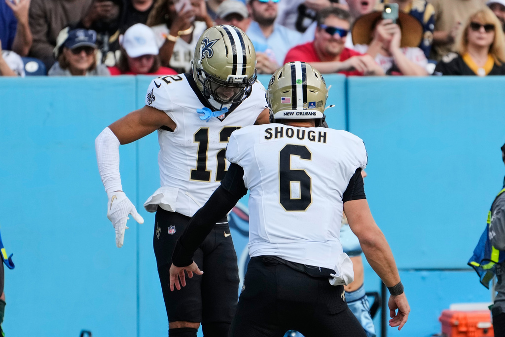 New Orleans Saints wide receiver Chris Olave (12) celebrates his touchdown reception with quarterback Tyler Shough (6) in the second half of an NFL football game against the Tennessee Titans, Sunday, Dec. 28, 2025, in Nashville, Tenn. (AP Photo/George Walker IV)