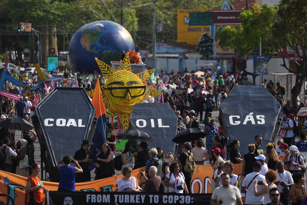 Climate activists protest with coffins that read coal, oil and gas during the COP30 U.N. Climate Summit, Saturday, Nov. 15, 2025, in Belem, Brazil. (AP Photo/Andre Penner)