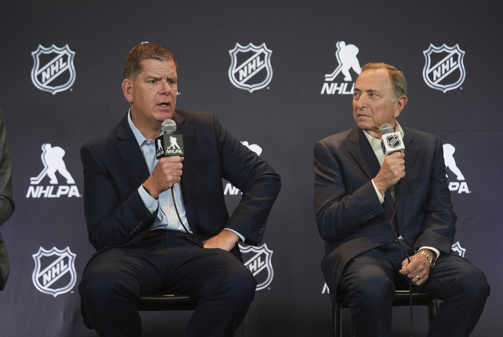 FILE - Marty Walsh, left, NHLPA Executive Director, and Gary Bettman, NHL Commissioner, conduct a joint news conference before the NHL hockey draft on June 27, 2025, in Los Angeles. (AP Photo/Damian Dovarganes, File)