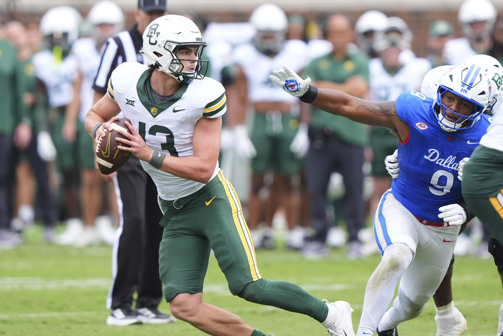Baylor quarterback Sawyer Robertson (13) eludes SMU defensive end Cameron Robertson (9) during the second half of an NCAA college football game Saturday, Sept. 6, 2025, in Dallas. (AP Photo/LM Otero)