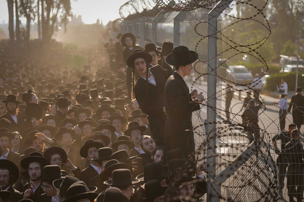 Ultra-Orthodox Jewish men protest against military recruitment and call for the release of detained draft resisters outside a military prison near Kfar Yona, Israel, Wednesday, June 17, 2026. (AP Photo/Ariel Schalit)