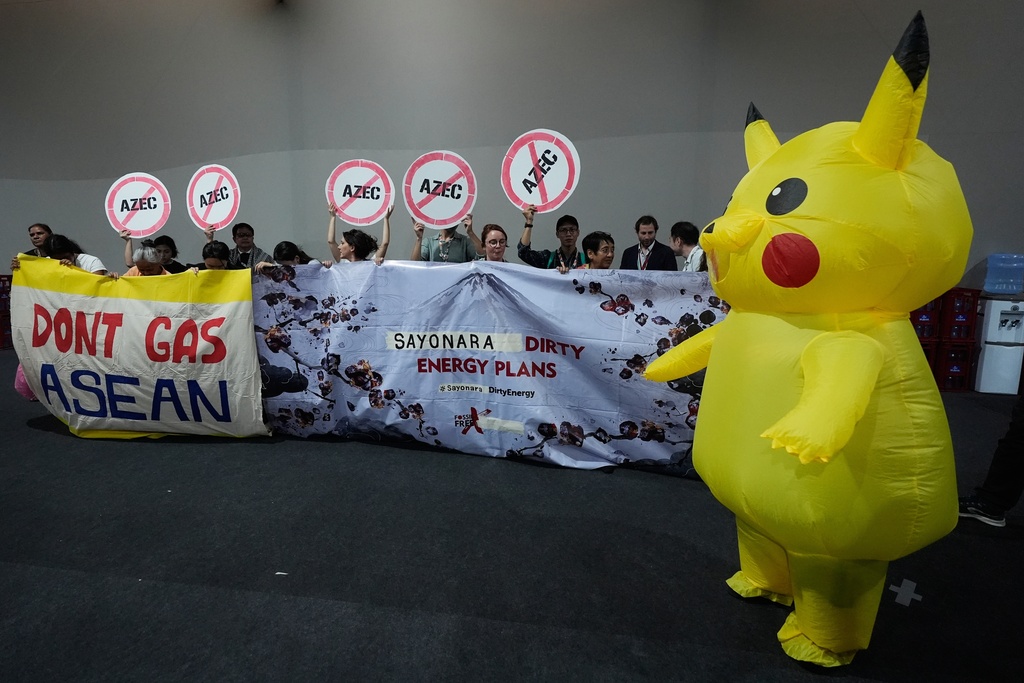Activists, and one dressed in a Pikachu costume, protest Japan's financing of coal and natural gas projects during the COP30 U.N. Climate Summit, Friday, Nov. 14, 2025, in Belem, Brazil. (AP Photo/Fernando Llano)