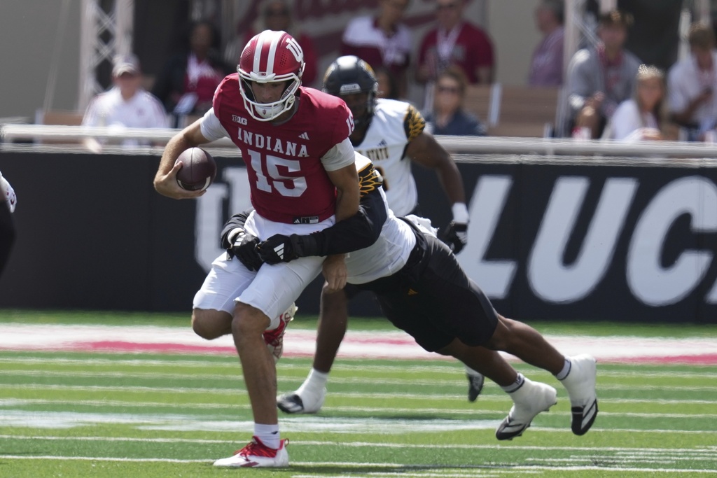 Indiana quarterback Fernando Mendoza (15) is tackled by Kennesaw State defensive lineman Marcus Patterson (6) during the first half of an NCAA college football game, Saturday, Sept. 6, 2025, in Bloomington, Ind. (AP Photo/Darron Cummings)