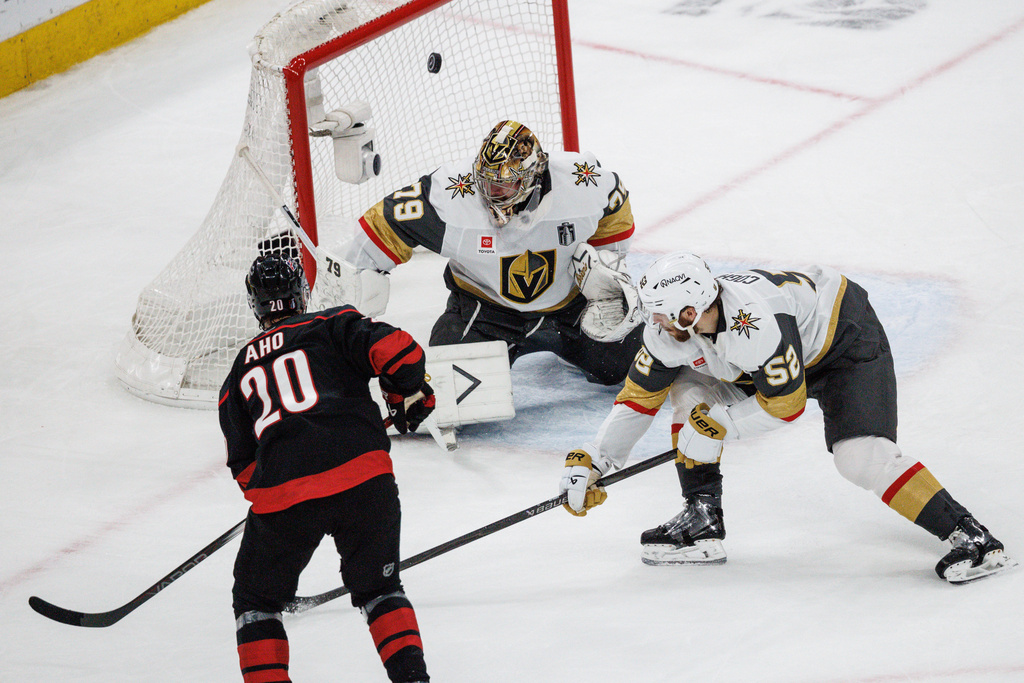 Carolina Hurricanes' Sebastian Aho (20) scores past Vegas Golden Knights' Carter Hart (79) as Dylan Coghlan (52) defends during the second period of Game 5 of the NHL hockey Stanley Cup Final series in Raleigh, N.C., Thursday, June 11, 2026. (AP Photo/Ben McKeown)
