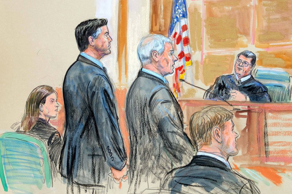 This courtroom sketch depicts former FBI Director James Comey, second from left, and his attorneys Jessica Carmichael, seated left, and Patrick J. Fitzgerald, standing right, during his arraignment at the federal courthouse in Alexandria, Va., Wednesday, Oct. 8, 2025. Assistant U.S. Attorney Tyler Lemons, is seated right. (Dana Verkouteren via AP)
