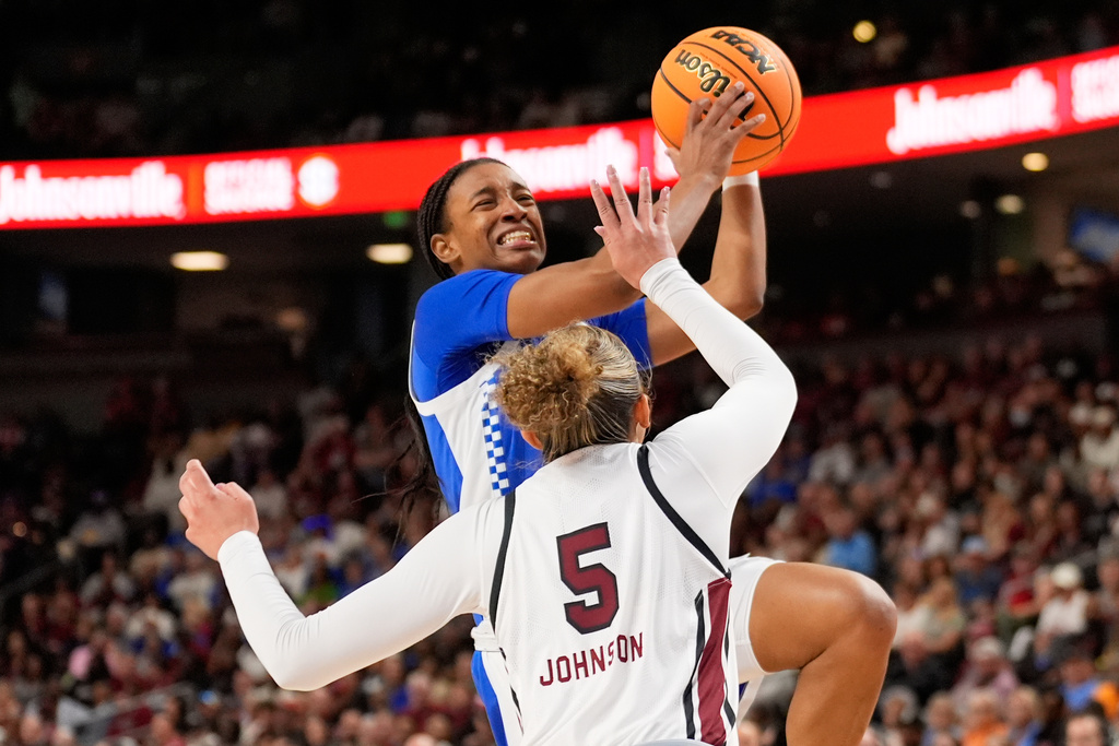 Kentucky guard Tonie Morgan shoots over South Carolina guard Tessa Johnson during first half of an NCAA college basketball game in the quarterfinals of the Southeastern Conference tournament, Friday, March 6, 2026, in Greenville, S.C. (AP Photo/Chris Carlson)