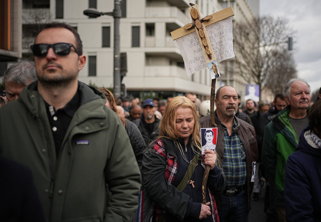 People take part in a march in Lyon, France, Saturday, Feb. 21, 2026, to pay tribute to Quentin Deranque, a 23-year-old nationalist activist who died from a beating after a clash between far-left and far-right supporters. (AP Photo/Laurent Cipriani)