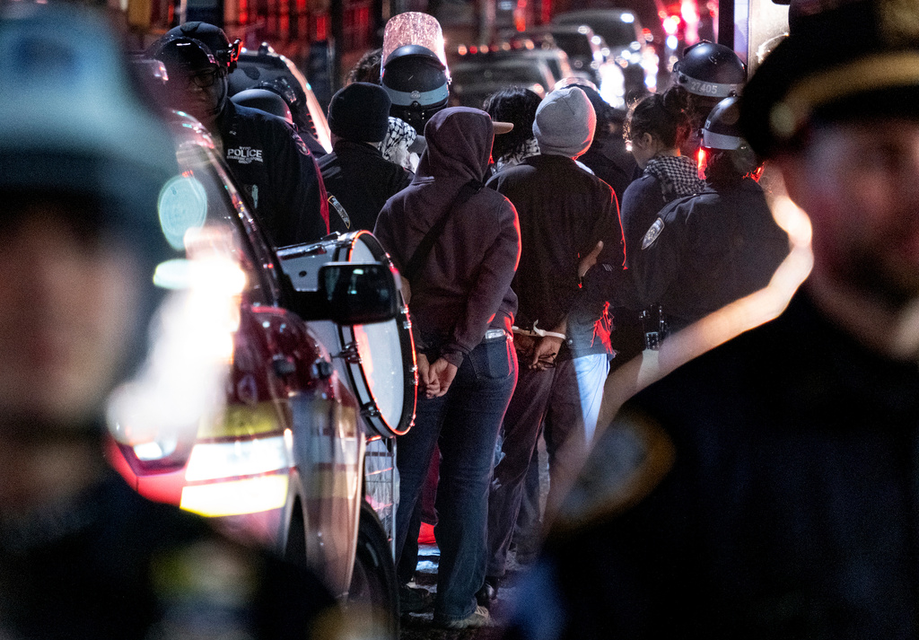 FILE - New York City police officers take people into custody near the Columbia University campus in New York Tuesday, April 30, 2024, after a building taken over by protesters earlier in the day was cleared, along with a tent encampment. (AP Photo/Craig Ruttle)
