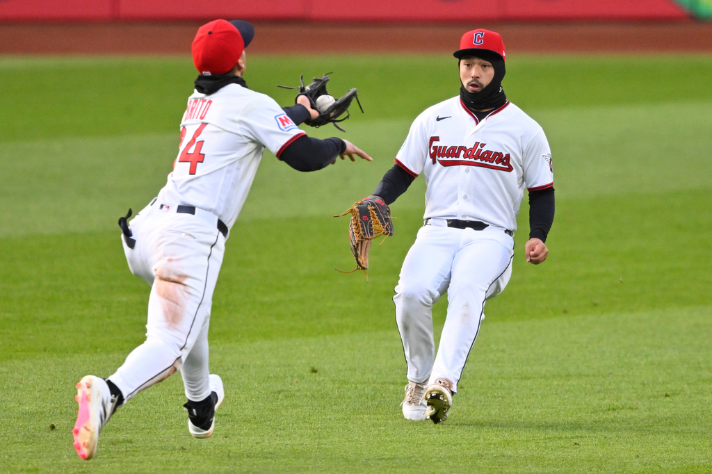 Cleveland Guardians second baseman Juan Brito, left, catches a fly ball in front of center fielder Steven Kwan, right, in the fourth inning of a baseball game against the Houston Astros in Cleveland, Monday, April 20, 2026. (AP Photo/David Richard)
