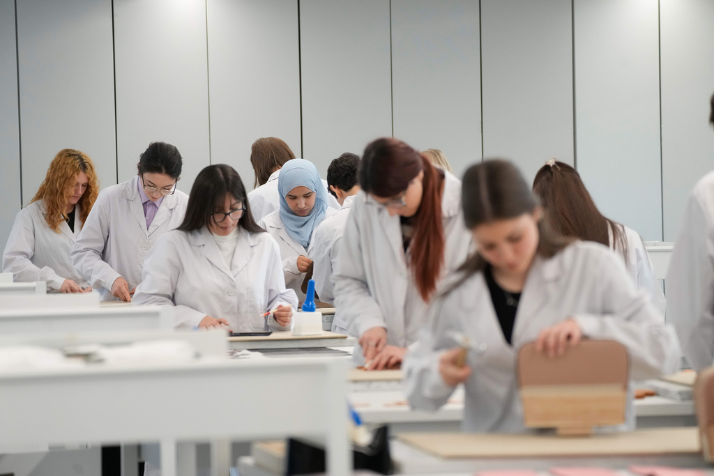 Leather good trainees work at the Prada factory in Scandicci, Italy, Friday, Nov. 28, 2025. (AP Photo/Gregorio Borgia)