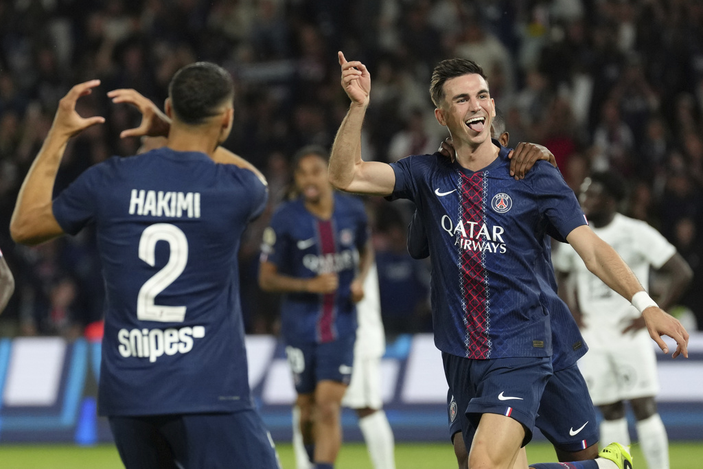 PSG's Fabian Ruiz celebrates after scoring his side opening goal with PSG's Achraf Hakimi during the League One soccer match Paris Saint-Germain against Angers at the Parc des Princes stadium, Friday, Aug. 22, 2025 in Paris. (AP Photo/Aurelien Morissard)