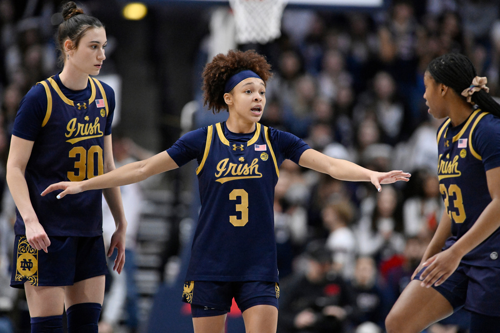 FILE - Notre Dame guard Hannah Hidalgo (3) talks with teammates Gisela Sanchez (30) and Iyana Moore (23) in the second half of an NCAA college basketball game against UConn, Monday, Jan. 19, 2026, in Storrs, Conn. (AP Photo/Jessica Hill)