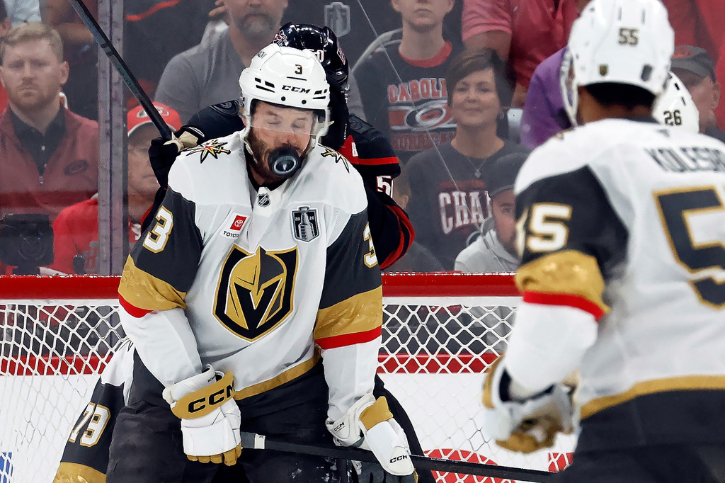 Vegas Golden Knights' Brayden McNabb takes a puck to the face during the first period in Game 2 of the NHL hockey Stanley Cup Final series against the Carolina Hurricanes in Raleigh, N.C., Thursday, June 4, 2026. (AP Photo/Karl DeBlaker)