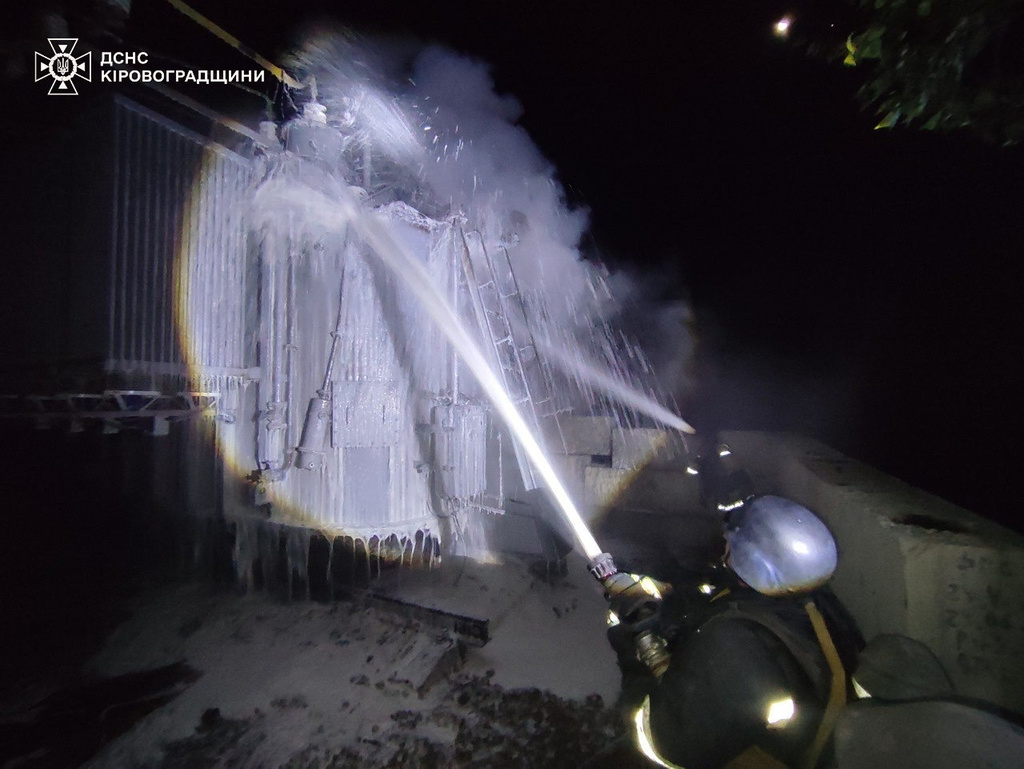 In this photo provided by the Ukrainian Emergency Services on Tuesday, Oct. 14, 2025, a rescue worker puts out a fire of a transformer damaged by a Russian strike in Kirovograd region, Ukraine. (Ukrainian Emergency Service via AP)