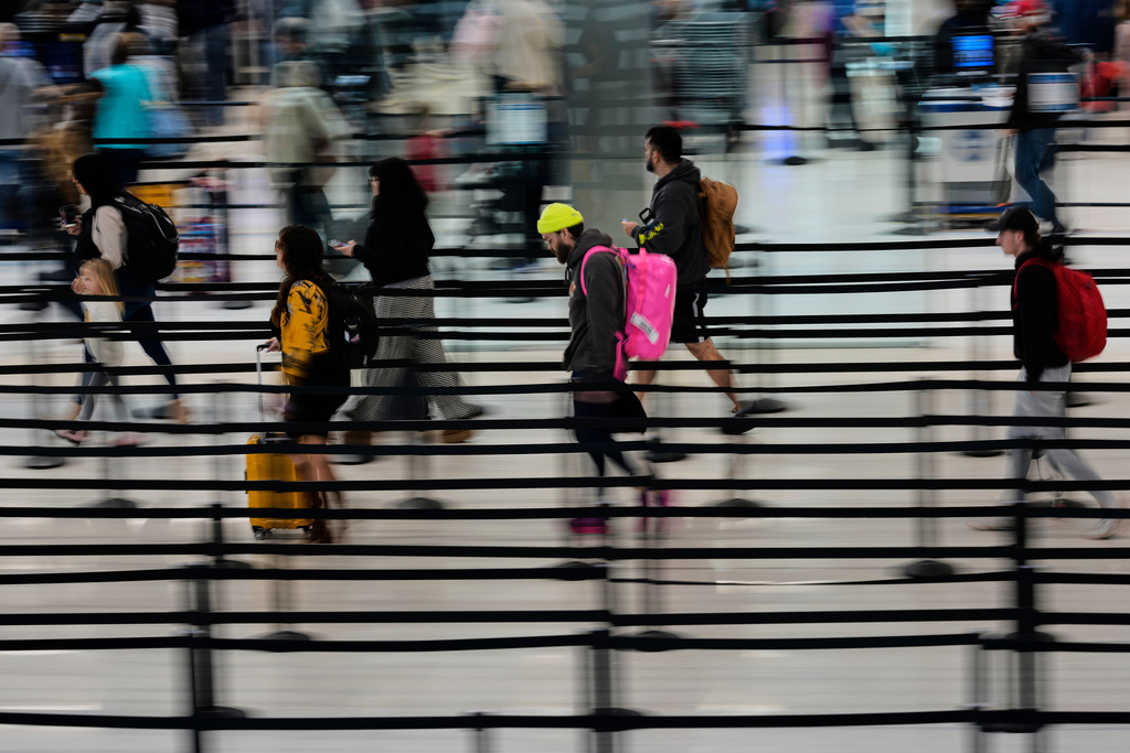 Travelers make their way through security lines at the Nashville International Airport, Tuesday, Nov. 25, 2025, in Nashville, Tenn. (AP Photo/George Walker IV)