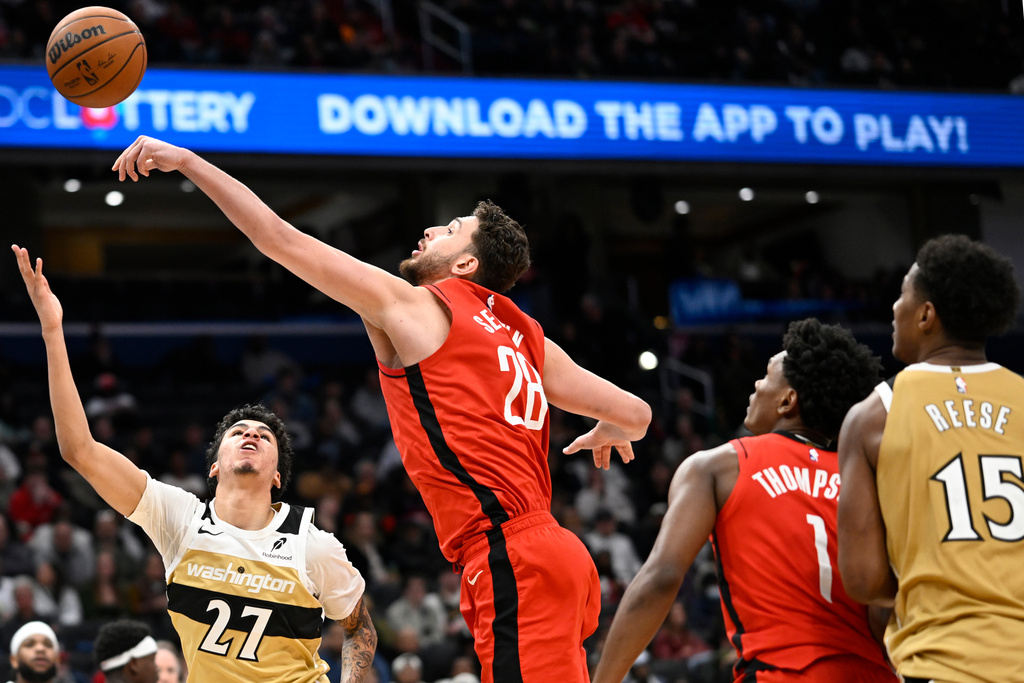 Washington Wizards guard Will Riley (27) has his shot blocked by Houston Rockets center Alperen Sengun during the second half of an NBA basketball game, Monday, March 2, 2026, in Washington. (AP Photo/John McDonnell)