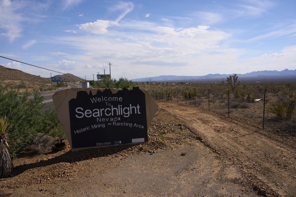 A truck drives along a highway Wednesday, Aug. 27, 2025, into Searchlight, Nev. (AP Photo/John Locher)