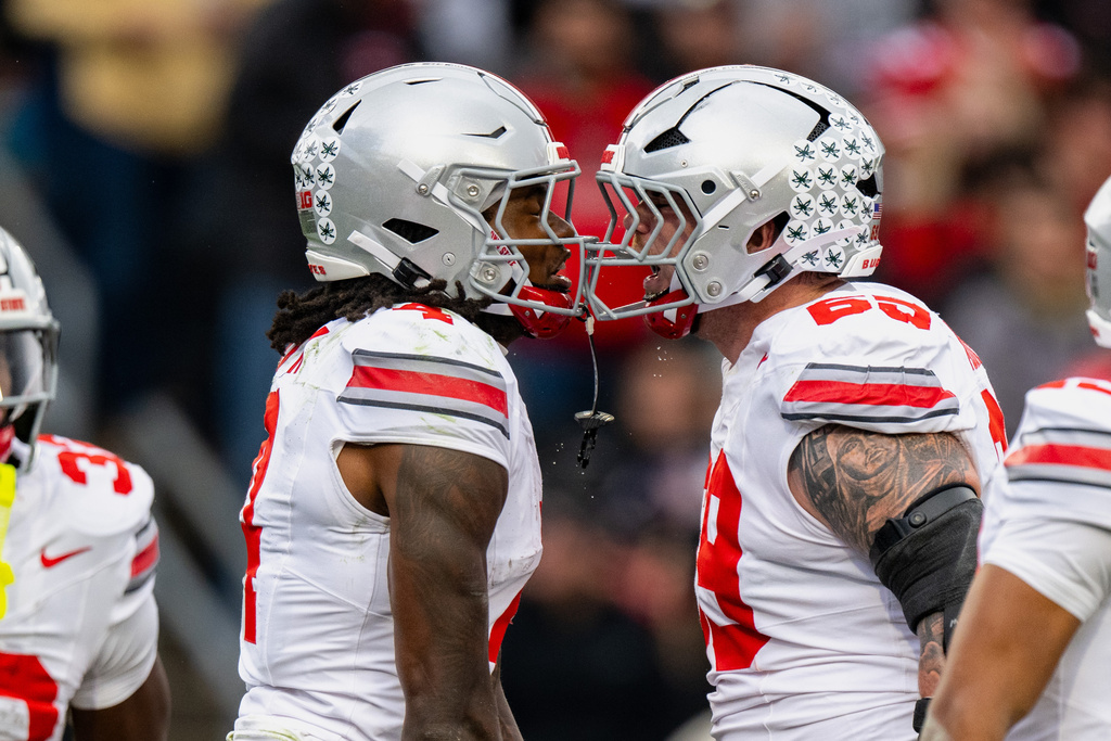 Ohio State wide receiver Jeremiah Smith (4) celebrates a touchdown with offensive lineman Ian Moore (69) during the first half of an NCAA college football game against Purdue, Saturday, Nov. 8, 2025, in West Lafayette, Ind. (AP Photo/Doug McSchooler)