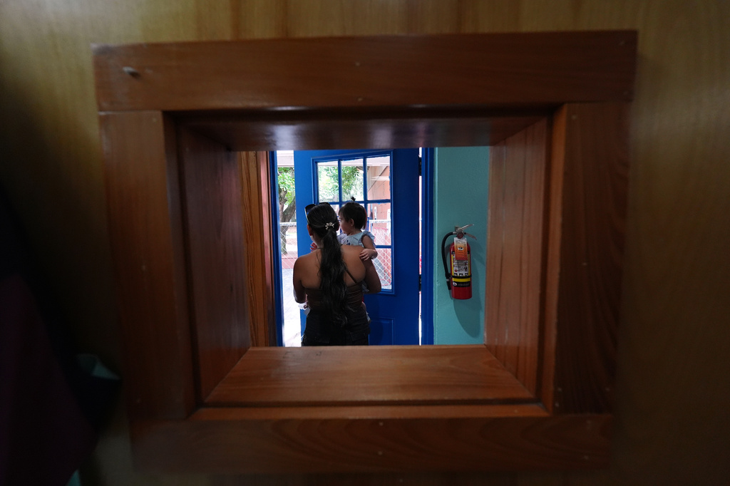 A mother picks up her young child from a Head Start preschool in Immokalee, Fla., Thursday, Sept. 10, 2026. (AP Photo/Rebecca Blackwell)