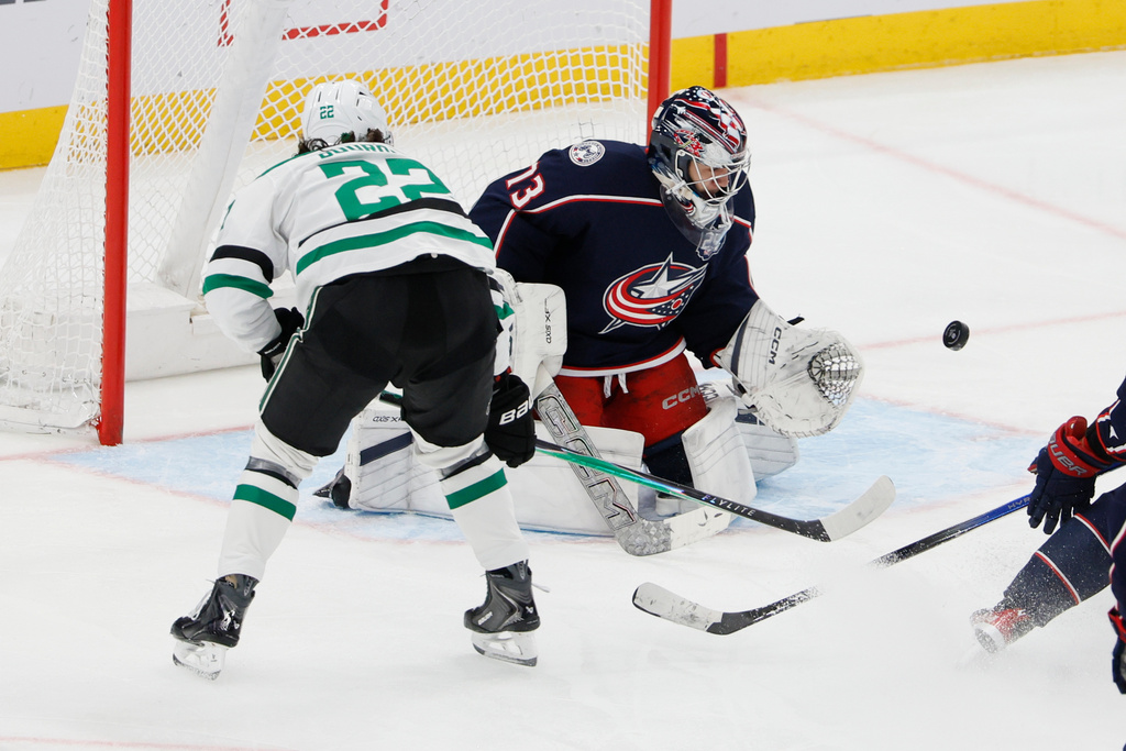 Columbus Blue Jackets' Jet Greaves, center, makes a save against Dallas Stars' Mavrik Bourque during the third period of an NHL hockey game, Thursday, Jan. 22, 2026, in Columbus, Ohio. (AP Photo/Jay LaPrete)