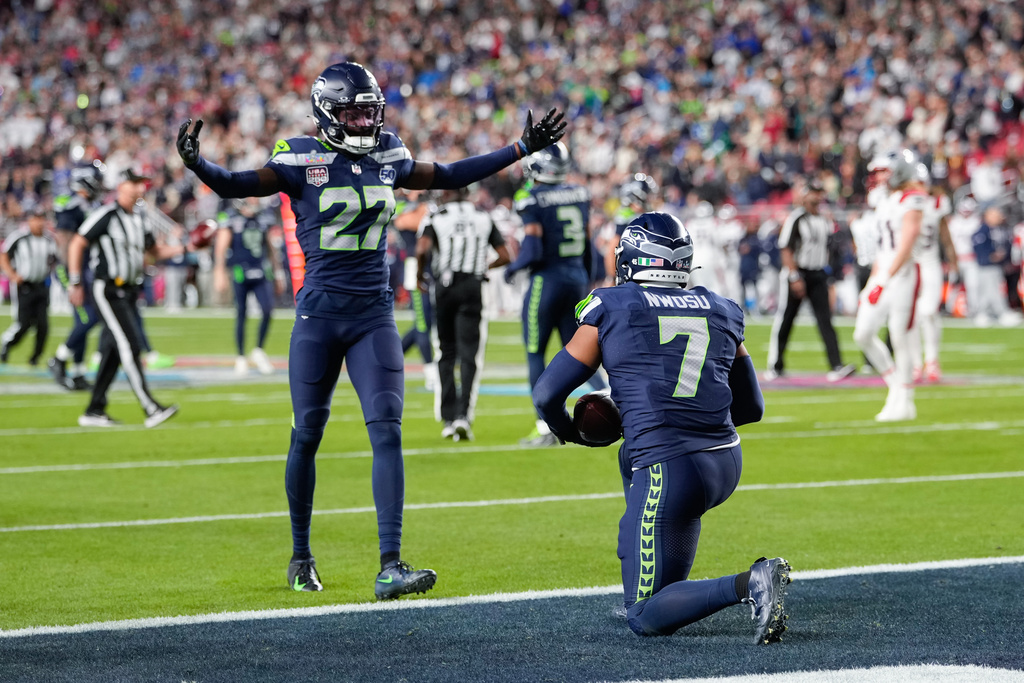 Seattle Seahawks linebacker Uchenna Nwosu (7) celebrates his touchdown on a fumble recovery with cornerback Riq Woolen (27) runs during the second half of the NFL Super Bowl 60 football game, Sunday, Feb. 8, 2026, in Santa Clara, Calif. (AP Photo/Mark J. Terrill)