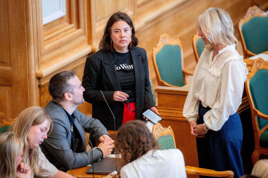 Naleraq's Qarsoq Hoeegh-Dam from Greenland , Inuit Ataqatigiit's Naaja H. Nathanielsen from Greenland and Minister of Health and Church Affairs Ida Auken during a meeting in the Folketing Hall at Christiansborg, Copenhagen, Thursday, Aug. 27, 2026. The meeting includes a vote on compensation in the so called "spiral case". (Ida Marie Odgaard/Ritzau Scanpix via AP)