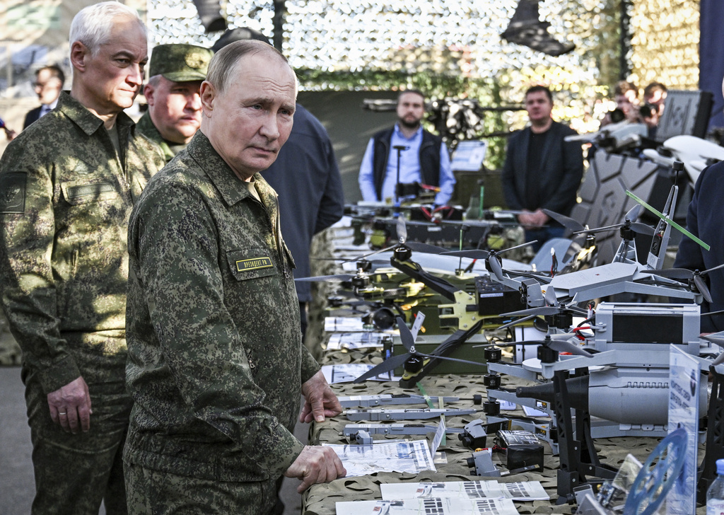 CORRECTS SOURCE FOR POOL - Russian President Vladimir Putin accompanied by Defence Minister Andrei Belousov, left, inspects Russian weapons and equipment during his visit to the Russian-Belarusian joint military drills "Zapad 2025" (West 2025) at the Mulino training ground in Nizhny Novgorod region, Russia, Tuesday, Sept. 16, 2025. (Sergey Bobylev/Sputnik, Kremlin Pool Photo via AP)