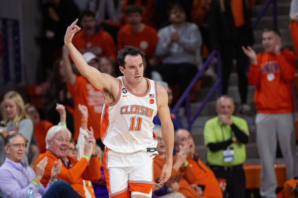 Clemson forward Nick Davidson (11) celebrates a three point basket against the Boston College during the first half of an NCAA college basketball game Tuesday, Jan. 13, 2026, in Clemson, S.C. (AP Photo/Scott Kinser)