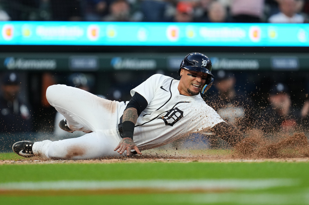 Detroit Tigers' Javier Báez scores against the Milwaukee Brewers during the fifth inning of a baseball game Wednesday, April 22, 2026, in Detroit. (AP Photo/Paul Sancya)