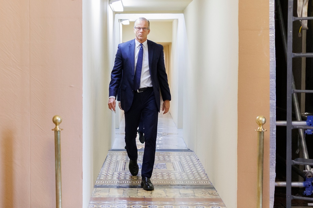 Senate Majority Leader John Thune, R-S.D., walks to the Senate Chamber ahead of a vote on Capitol Hill on Sunday, March 22, 2026, in Washington. (AP Photo/Tom Brenner)
