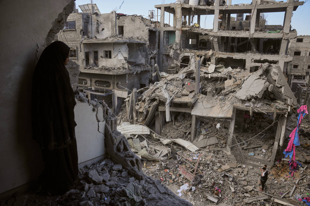 Palestinians inspect the rubble of the Ismail family home, destroyed in Israeli airstrike at Al-Maghazi camp, in the central Gaza Strip, Thursday, May 21, 2026. (AP Photo/Abdel Kareem Hana)