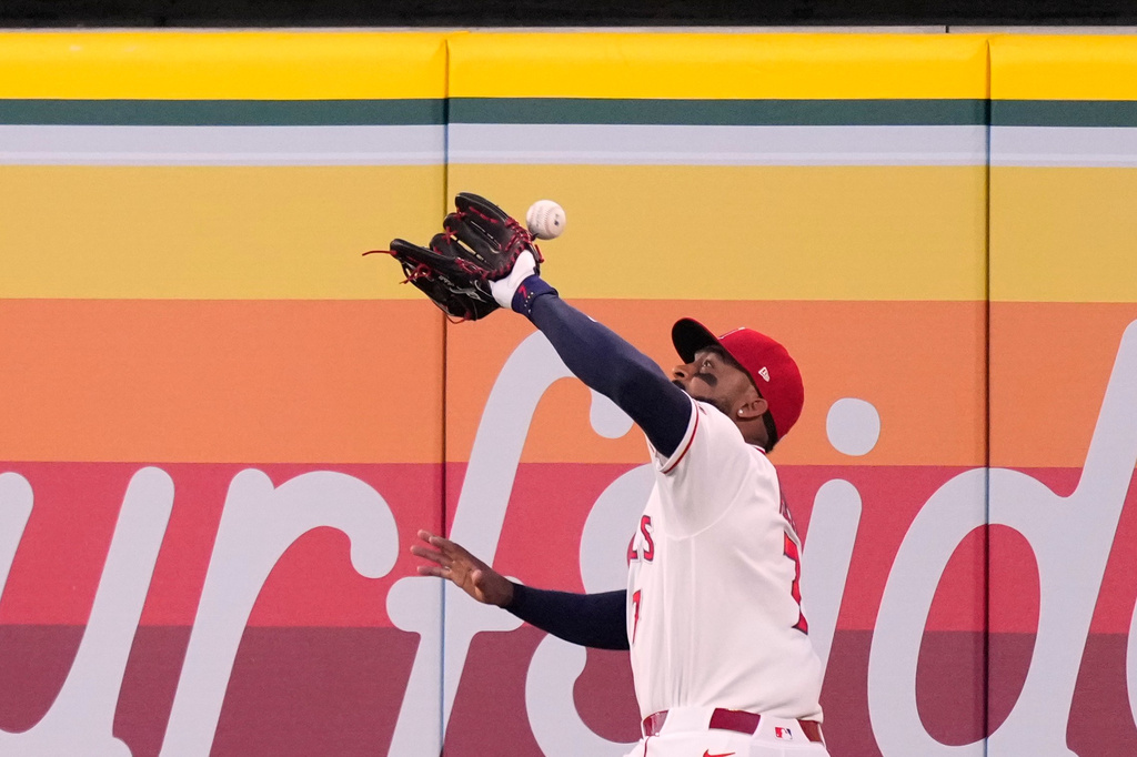 Los Angeles Angels right fielder Jo Adell misplays a ball hit by Colorado Rockies' TJ Rumfield that hit him in the head and then bounced out for a solo home run during the fourth inning of a baseball game Tuesday, June 2, 2026, in Anaheim, Calif. (AP Photo/Mark J. Terrill)