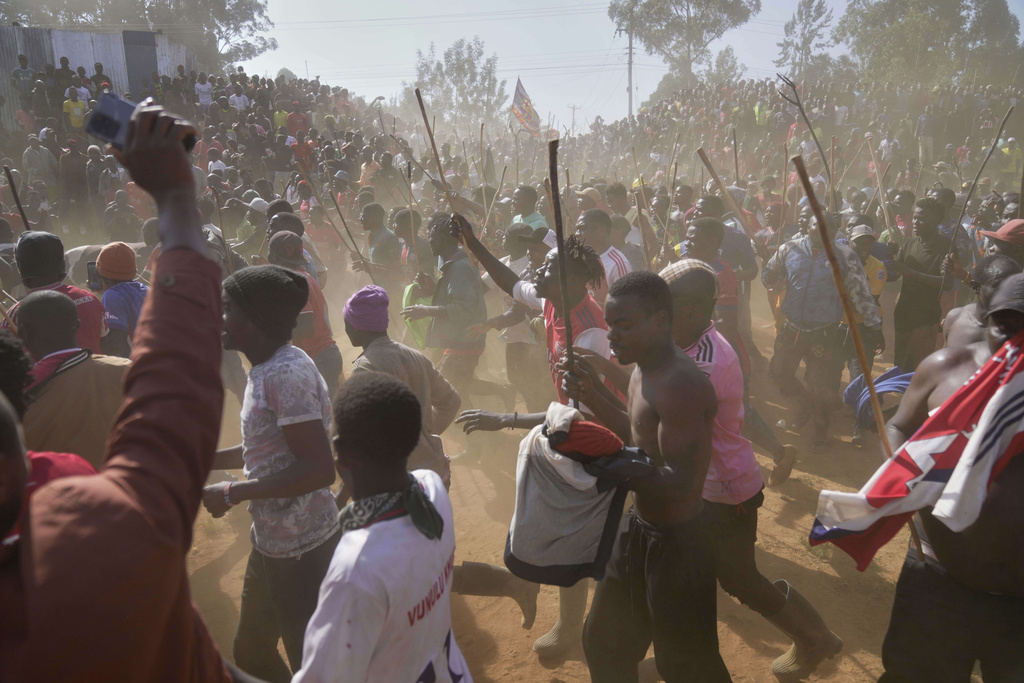 A crowd of spectators dances and sings after bull Shakahola won bullfighting match, in Kakamega, Kenya, Saturday, Nov. 29, 2025. (AP Photo/Brian Inganga)