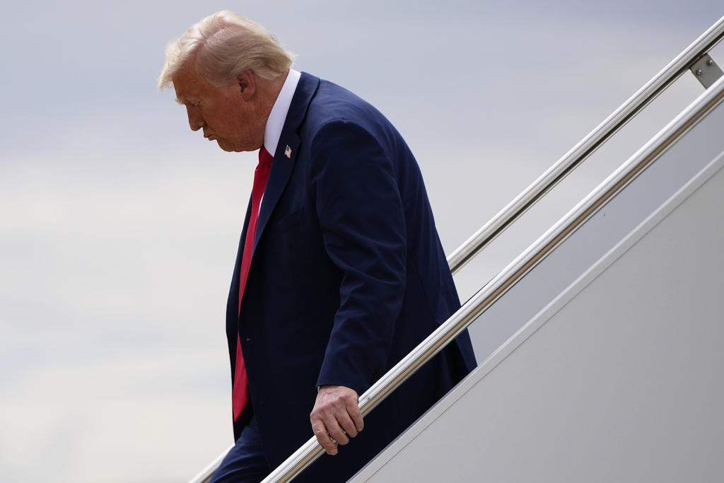 President Donald Trump disembarks Air Force One, Sunday, Sept. 21, 2025, upon arriving at Luke Air Force Base, Ariz., to attend a memorial for conservative activist Charlie Kirk. (AP Photo/Julia Demaree Nikhinson)