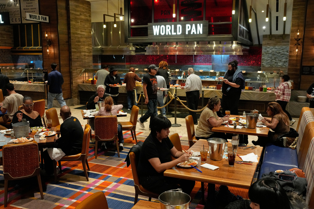 People eat at the A.Y.C.E Buffet in the Palms resort-casino Wednesday, Jan. 28, 2026, in Las Vegas. (AP Photo/John Locher)