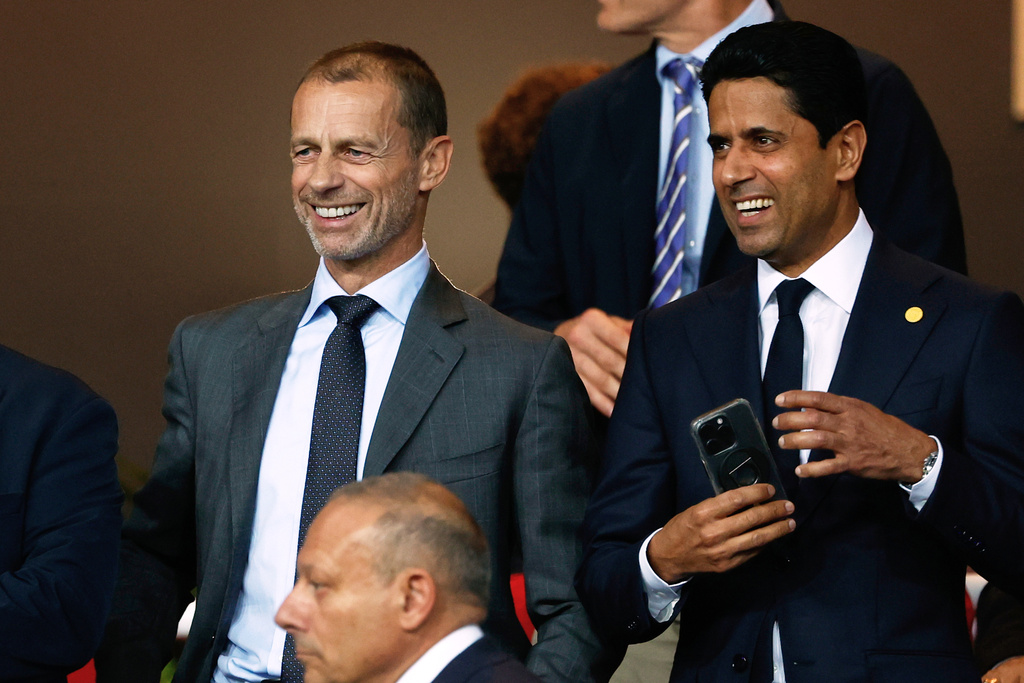 FILE - UEFA President Aleksander Ceferin, left, and Paris Saint-Germain Nasser Al-Khelaifi smile prior to the Champions League opening phase soccer match between Barcelona and Paris Saint-Germain at the Lluis Companys Olympic Stadium in Barcelona, Spain, Oct. 1, 2025. (AP Photo/Joan Monfort, File)