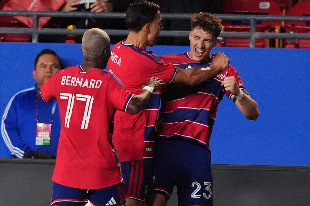 FC Dallas forward Logan Farrington (23) celebrates after his goal with forward Petar Musa, center, and forward Bernard Kamungo (77) during the first half of an MLS soccer match against Toronto FC in Frisco, Texas, Saturday, Feb. 21, 2026. (AP Photo/LM Otero)