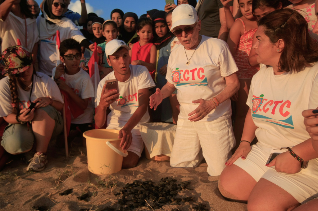 Mona Khalil, a Lebanese conservationist who died on Friday after being wounded in an Israeli strike on her home on Lebanon's southern coast, releases baby sea turtles in Mansouri village near Tyre city, south Lebanon, July 29, 2018. (AP Photo/Mohammed Zaatari) CORRECTION: Corrects byline from Hussein Malla to Mohammed Zaatari
