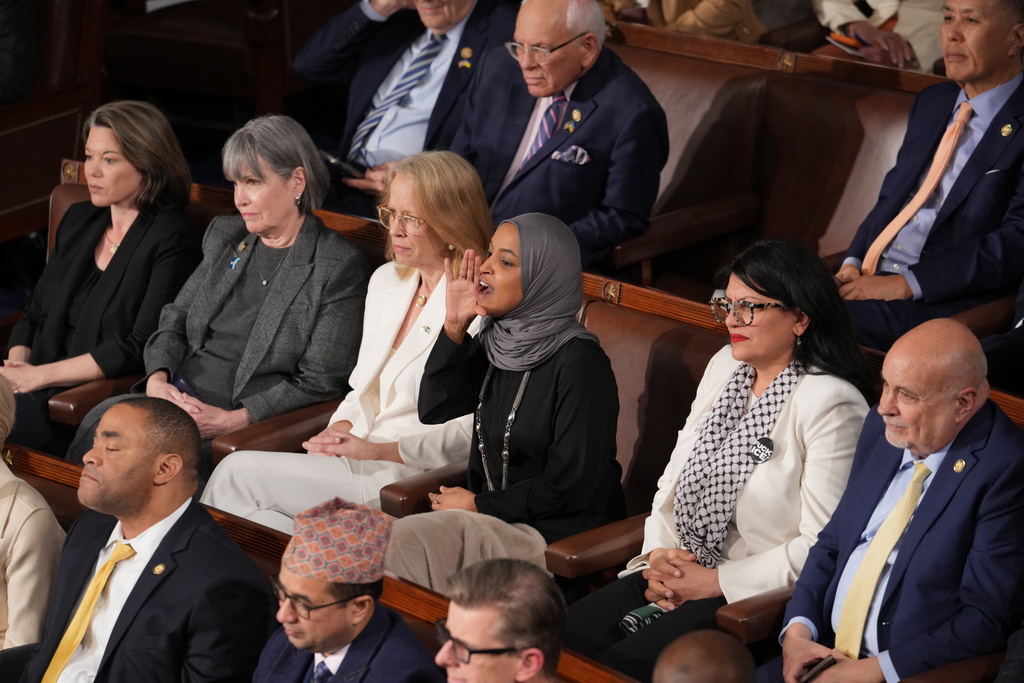Rep. Ilhan Omar, D-Minn., center, reacts as President Donald Trump gives his State of the Union address to a joint session of Congress, at the Capitol in Washington, Tuesday, Feb. 24, 2026. (AP Photo/J. Scott Applewhite)
