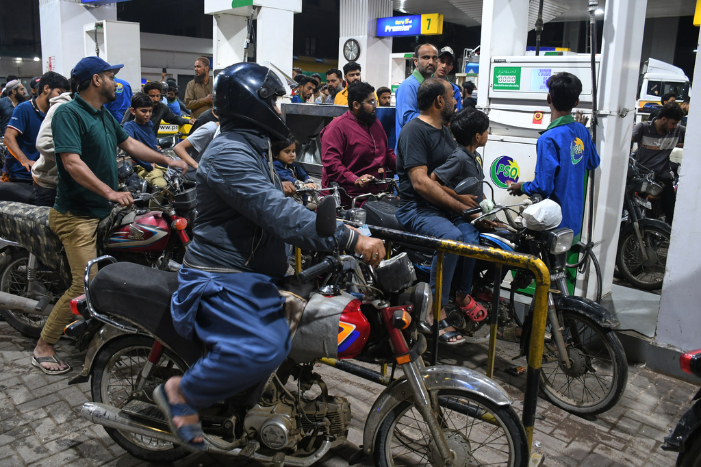 Motorcyclists crowd into a filling station as they wait their turn to buy fuel, in Karachi, Pakistan, Thursday, April 2, 2026. (AP Photo/Ali Raza)